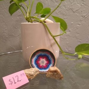 This is a wooden bowl with beads